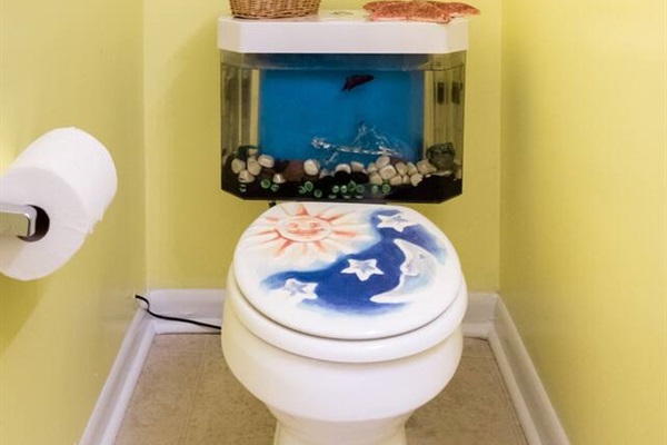 The fish tank toilet is just one of the unique touches in this bright, colorful home.