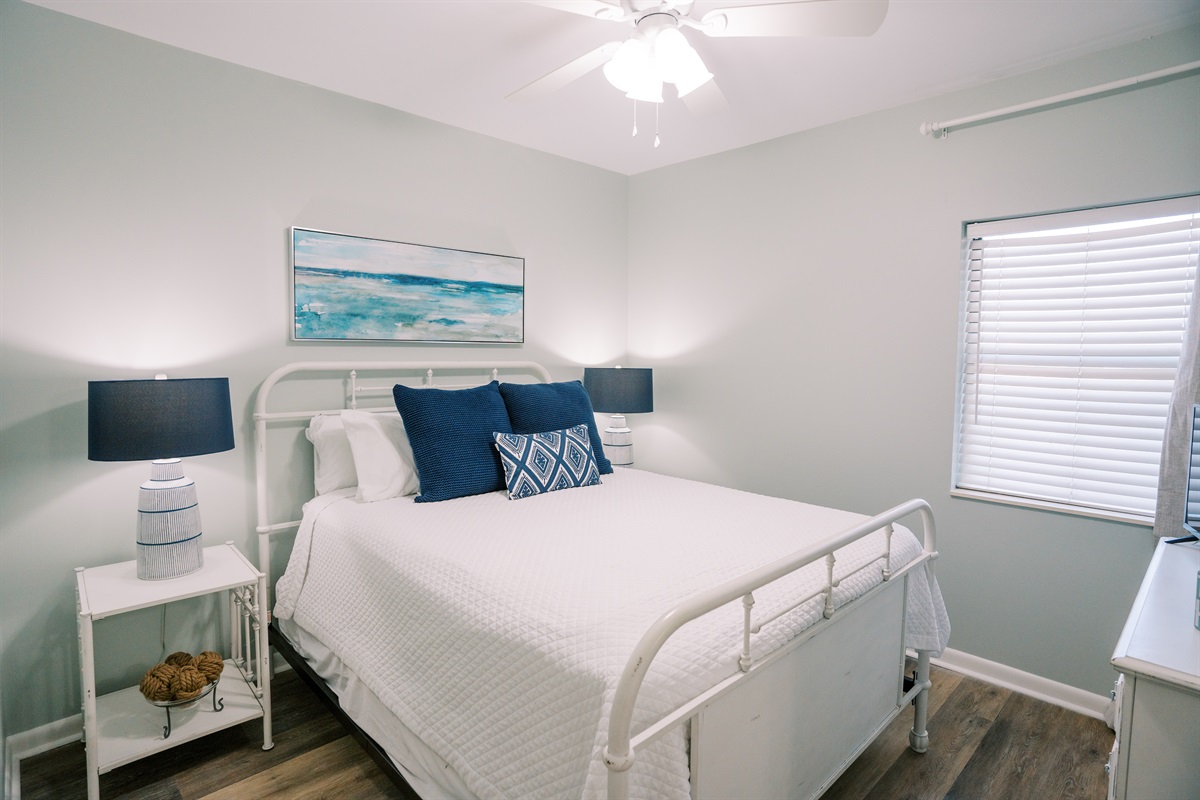 Comfortable queen bedroom with a clean, coastal feel and plenty of space to settle in.