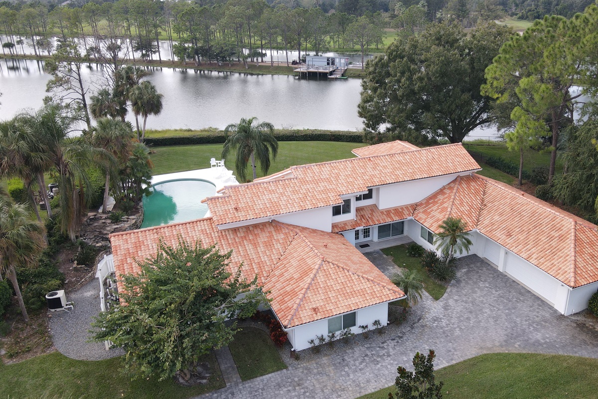 Drone view of house and ski dock across the lake