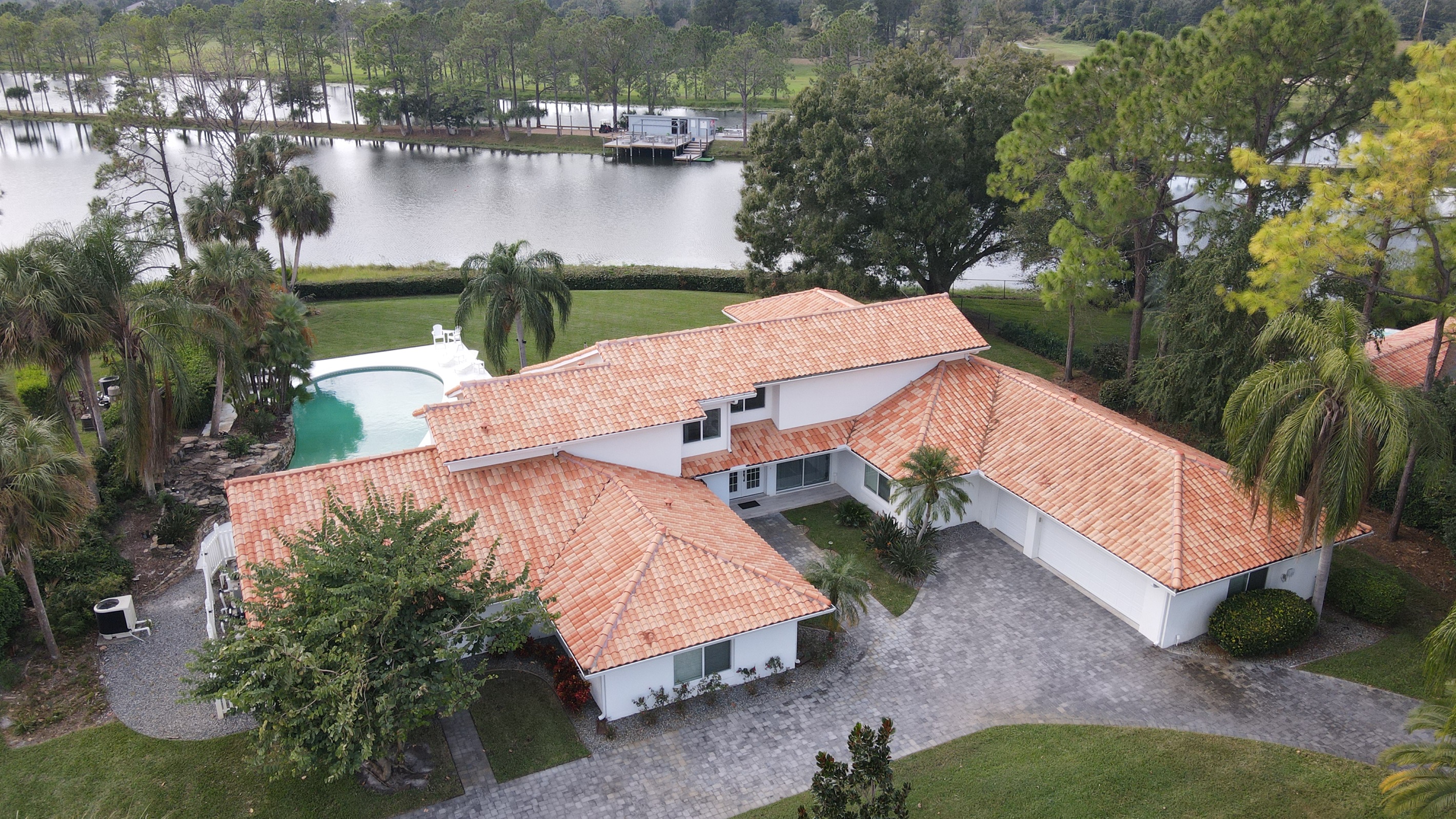 Drone view of house and ski dock across the lake