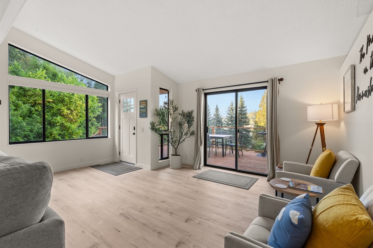 Step inside to a bright, open space with armchairs by the sliding glass door—perfect for taking in the view