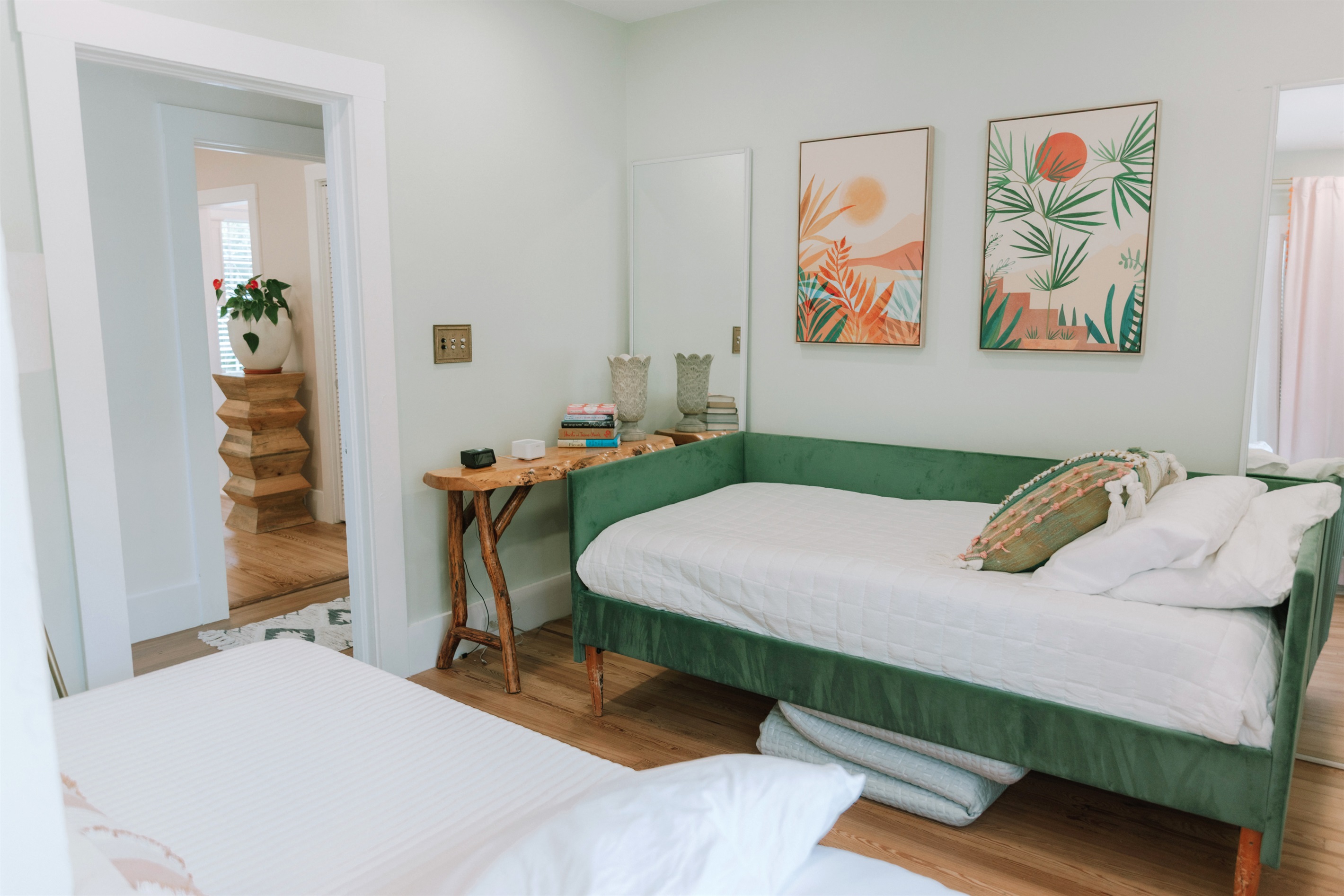 The third bedroom has a daybed and a pullout bed, garnished with colorful art throughout.