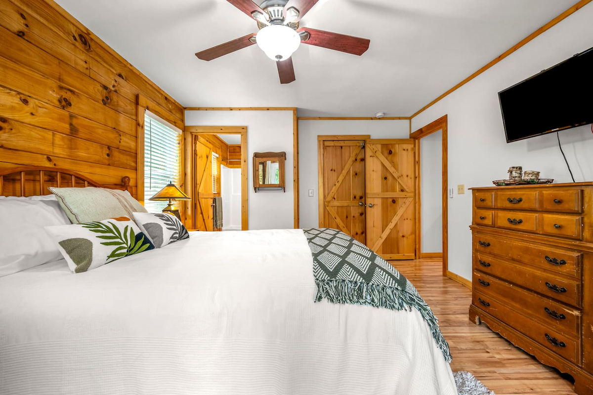 Bedroom #1 located on the main level of the cabin with queen bed and en suite bathroom