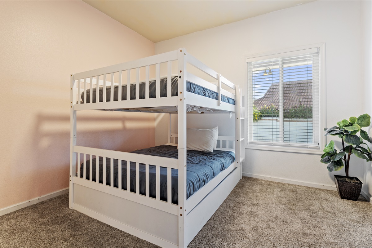 Designed with families in mind, this bright and cheerful bunk room offers cozy sleeping space and plenty of natural light.
