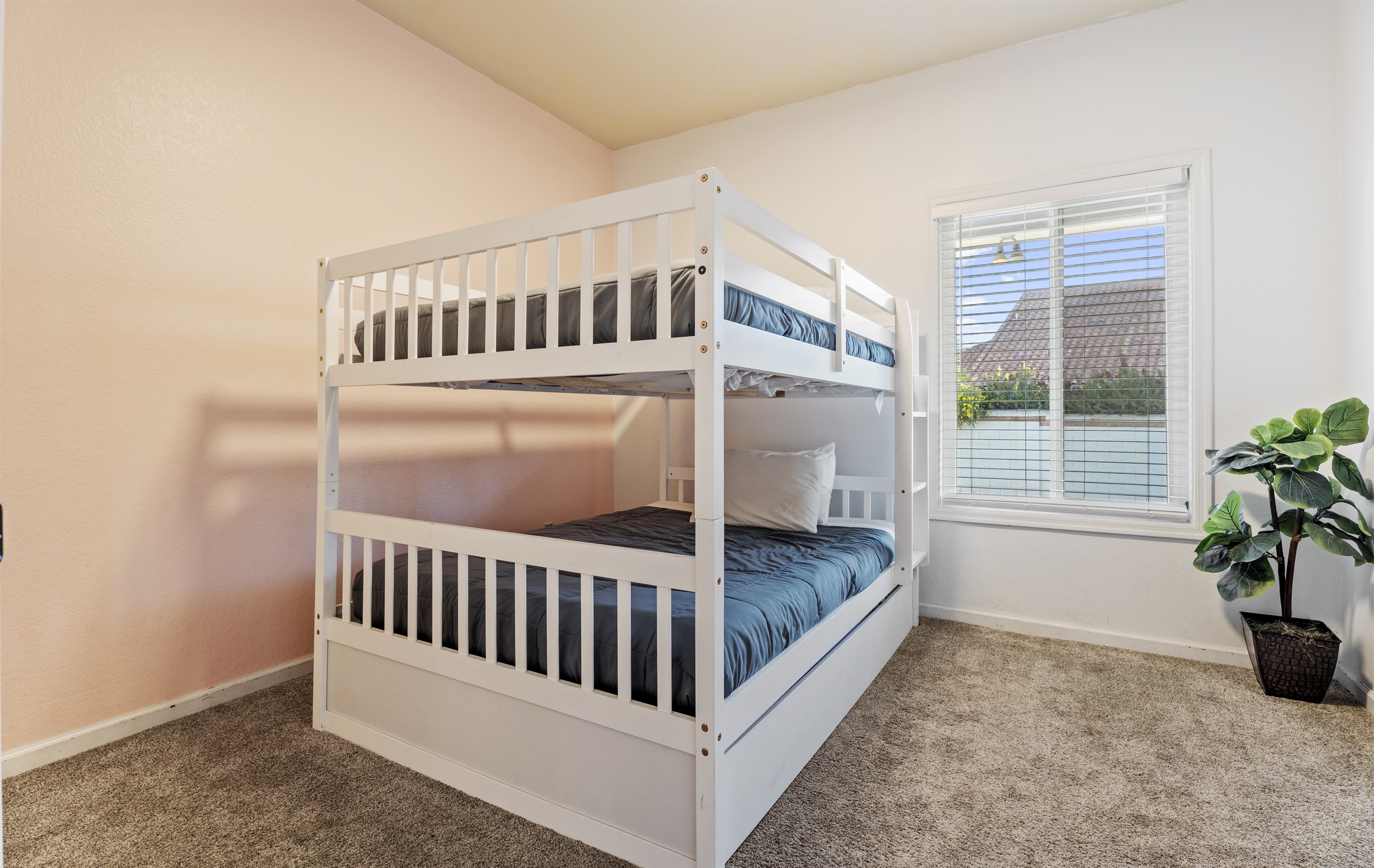 Designed with families in mind, this bright and cheerful bunk room offers cozy sleeping space and plenty of natural light.