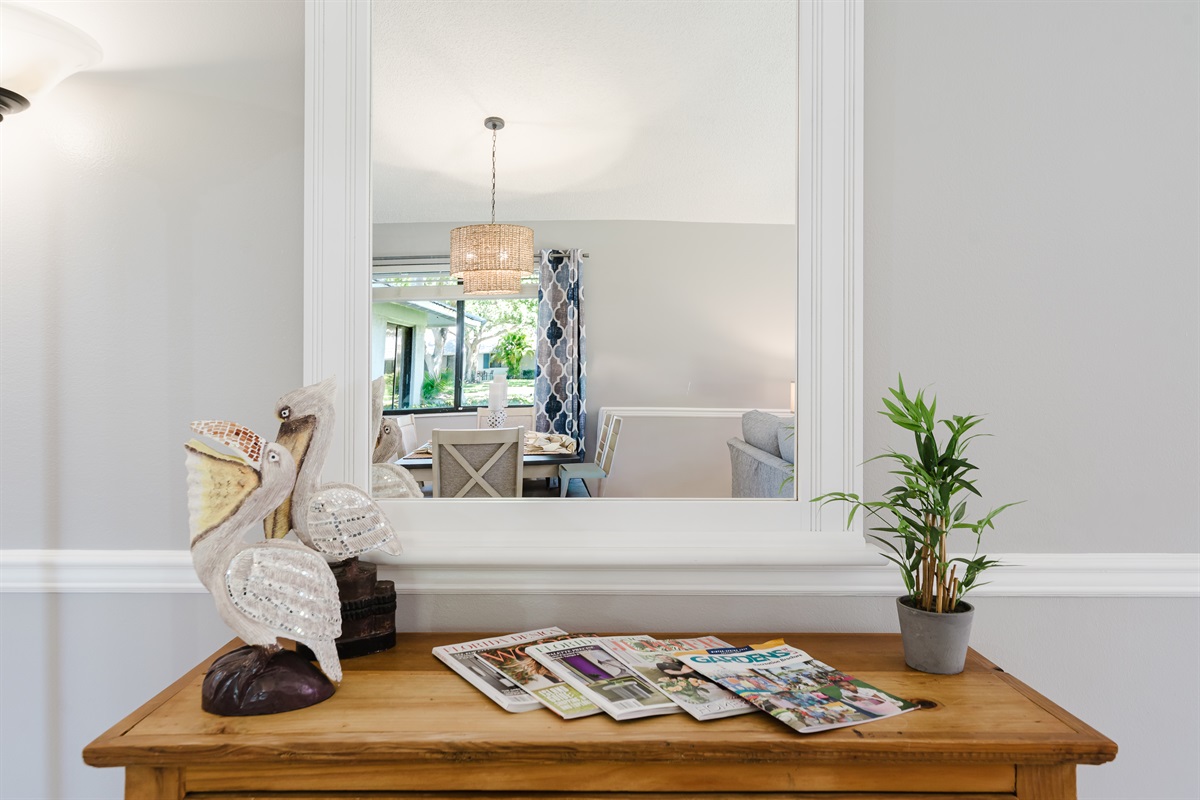 Bright and spacious coastal-inspired living room with oversized seating, Smart TV, cable, and direct access to the patio and outdoor dining area.
