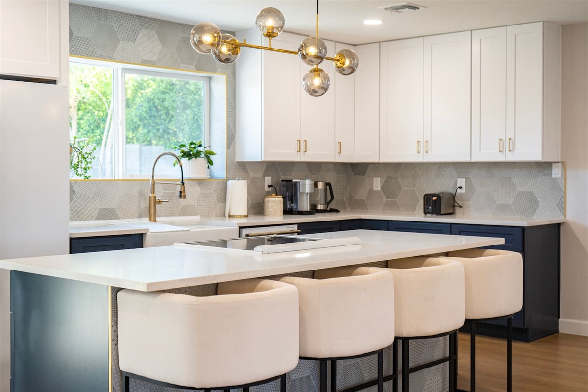 Modern chef’s kitchen with spacious island seating—perfect for morning coffee, shared meals, and gathering before a day exploring Scottsdale”