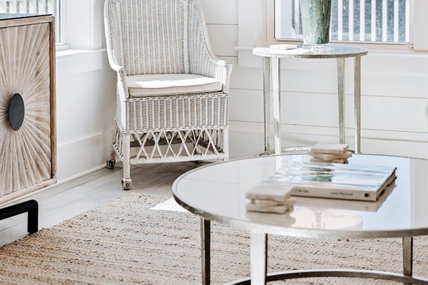 Spacious, open-concept living area filled with natural light, featuring ample seating and seamless flow to the kitchen and outdoor pool area.