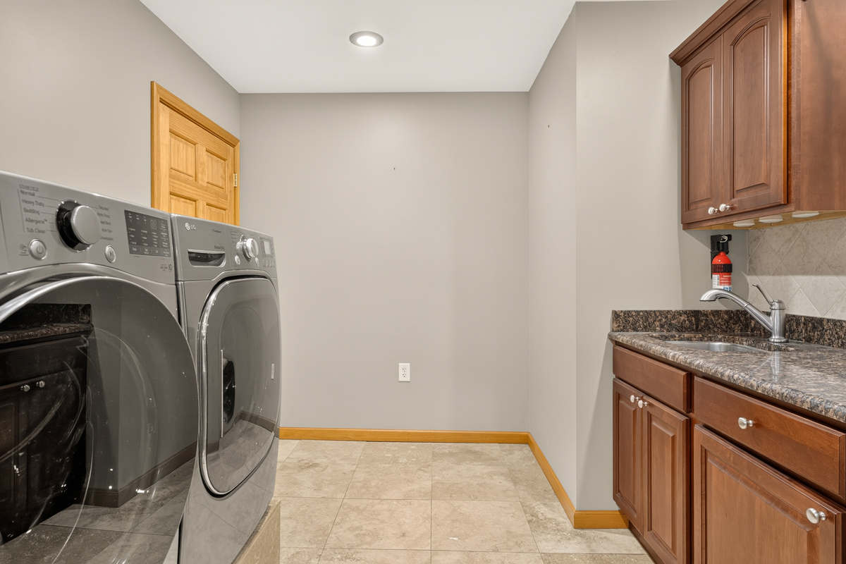 Laundry room with washer, dryer, and countertop
