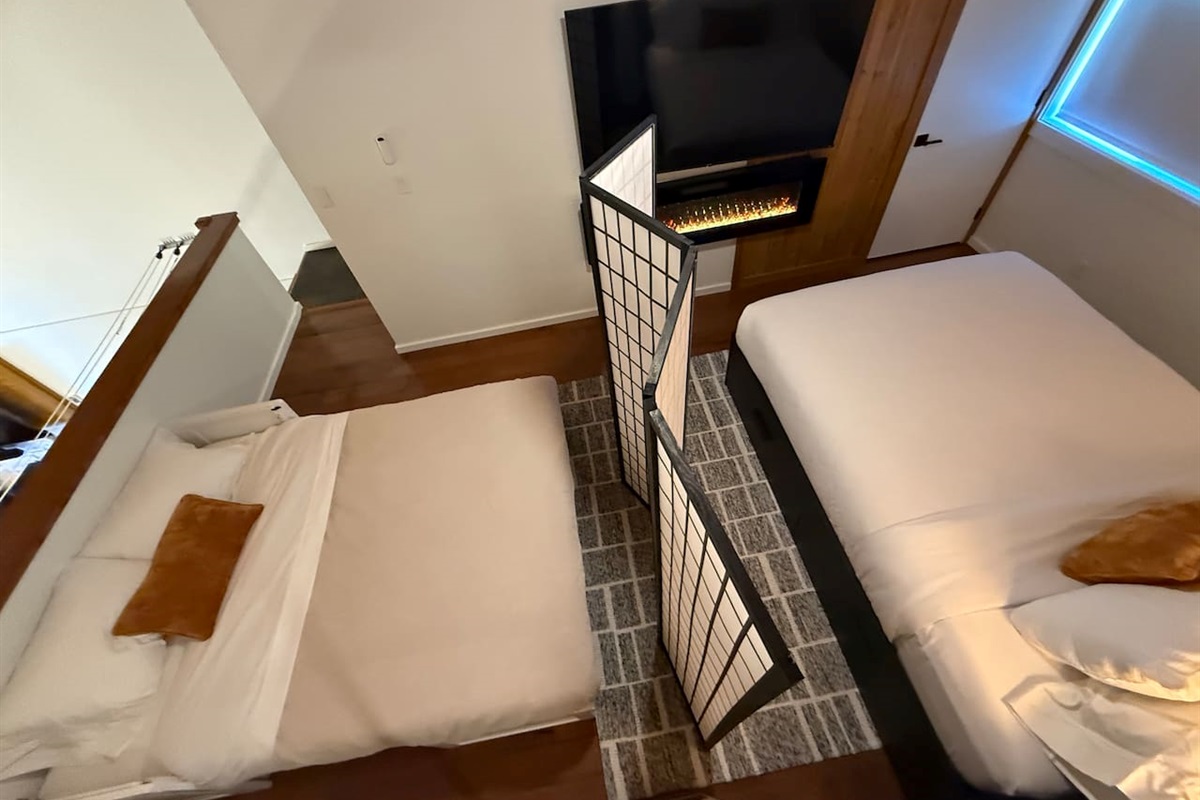 Two sleeping areas with privacy screen—both see the TV , mirrored closet & under-bed storage.