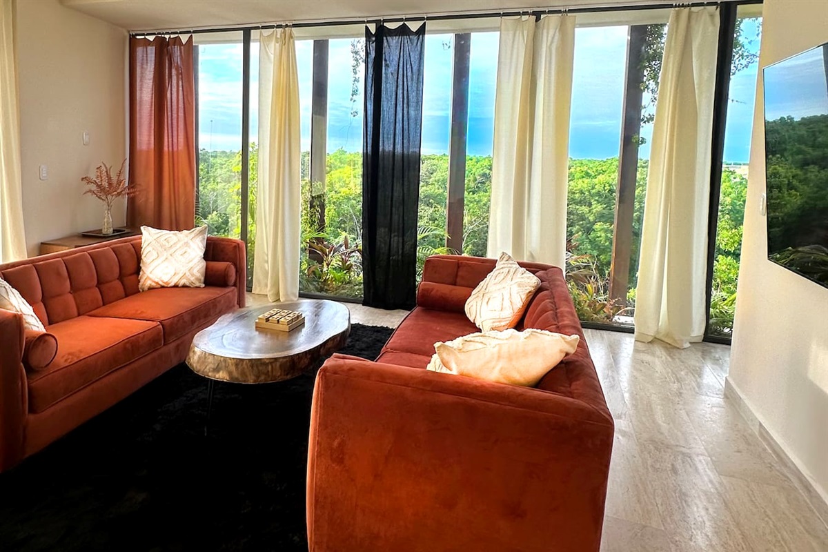 The living Area is surrounded by views of the Tulum jungle