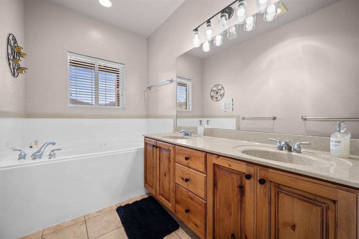 Primary bathroom with dual vanity and ample space to get ready.