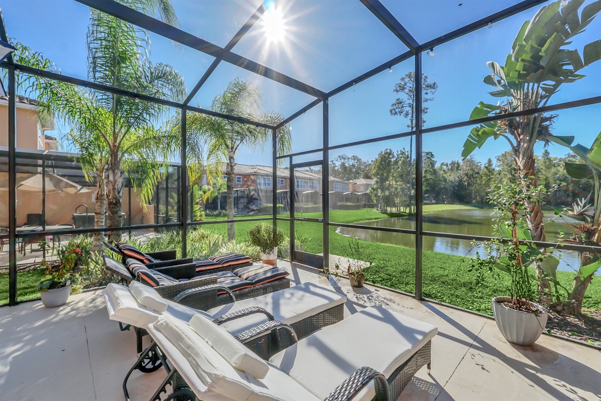 Private covered lanai with seating area, hot tub and lounge chairs