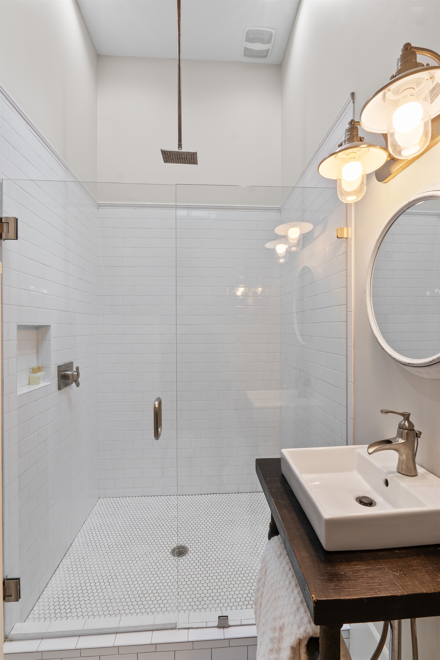 The carriage house bathroom features a large walk-in shower, adding a touch of luxury and convenience for guests.