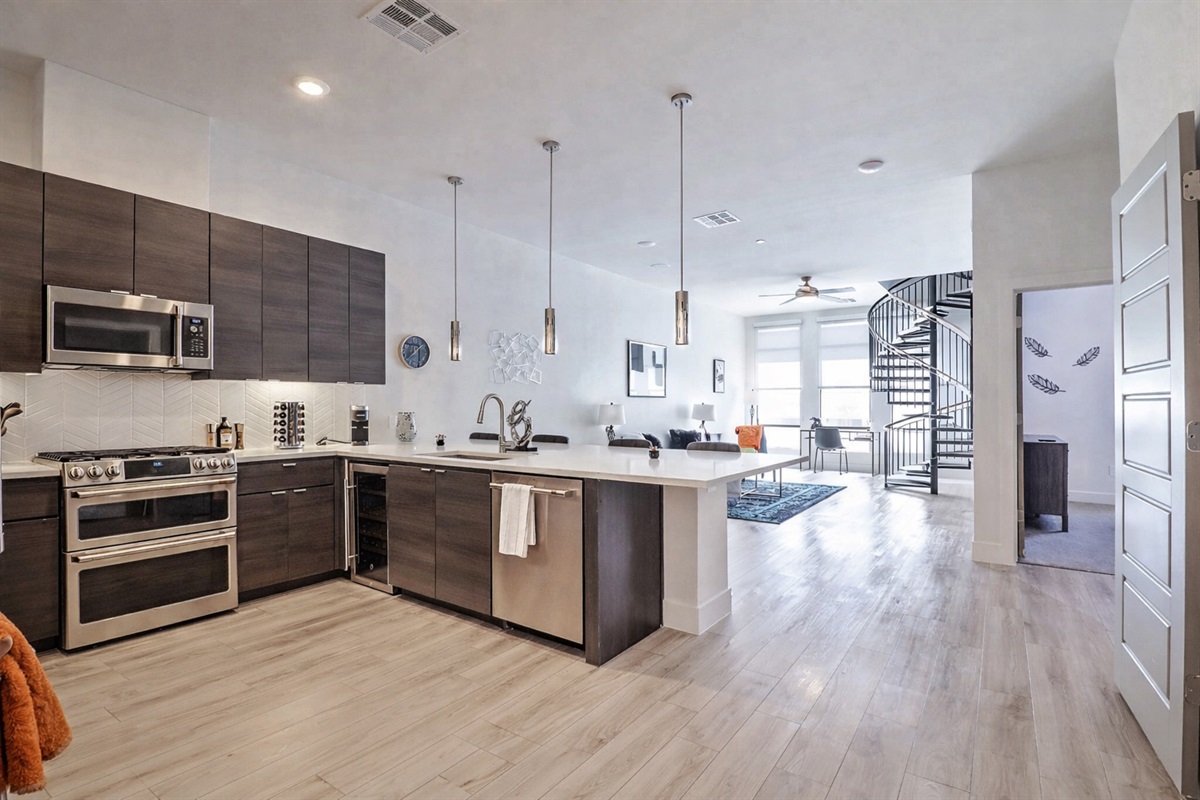 Modern, fully stocked kitchen with full-size refrigerator, stove, oven, microwave, and dishwasher. Includes coffee maker, toaster, cookware, and dining essentials—ideal for everything from quick breakfasts to home-