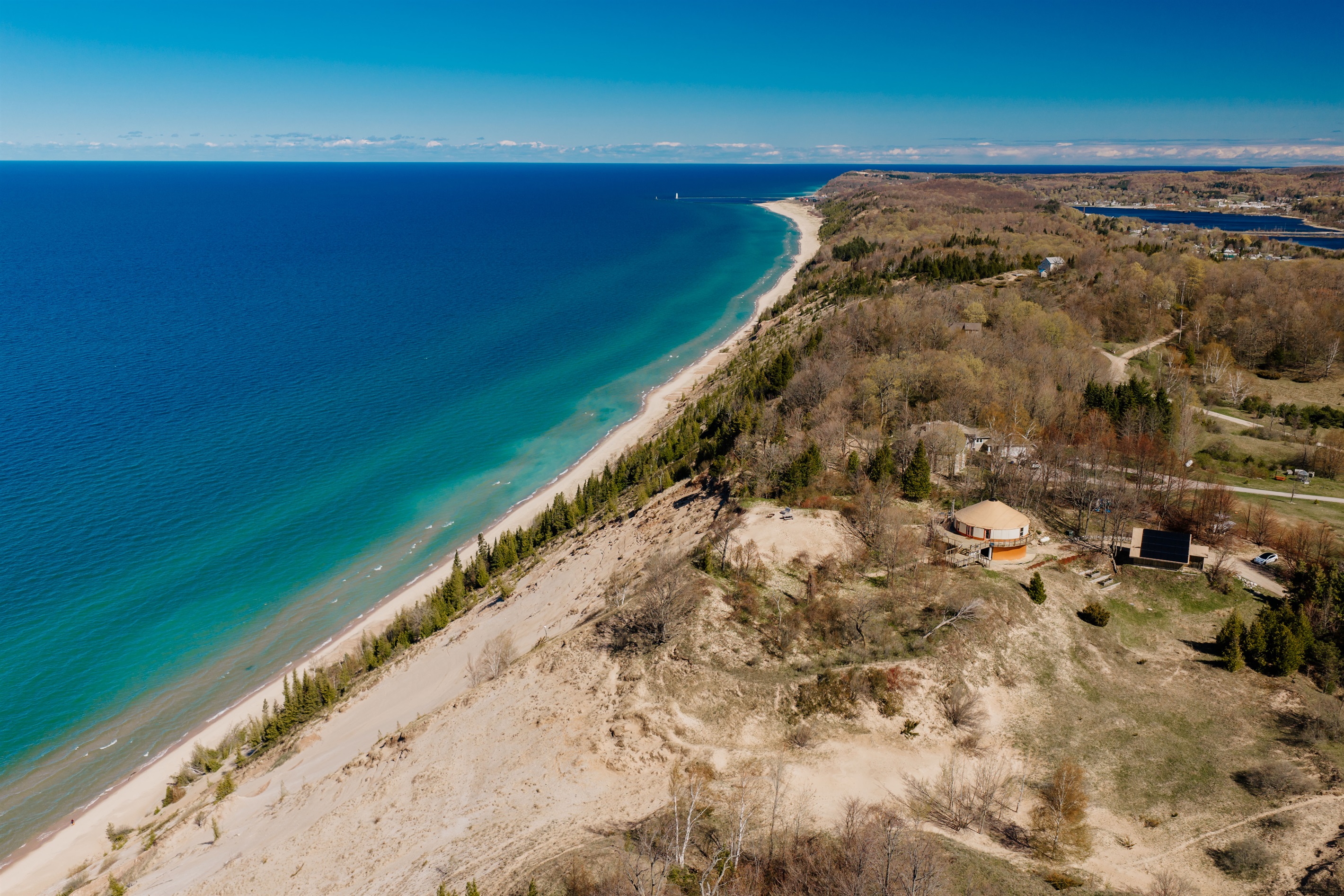 Perched high above the dunes with sweeping Lake Michigan shoreline views, this one-of-a-kind retreat offers unmatched scenery and privacy.
