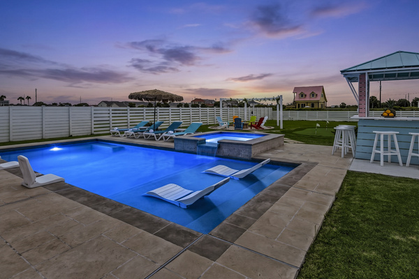 Evening Resort Ambiance
The illuminated blue pool and heated spa create a luxurious nighttime atmosphere, offering the perfect place to unwind after a day at the beach.