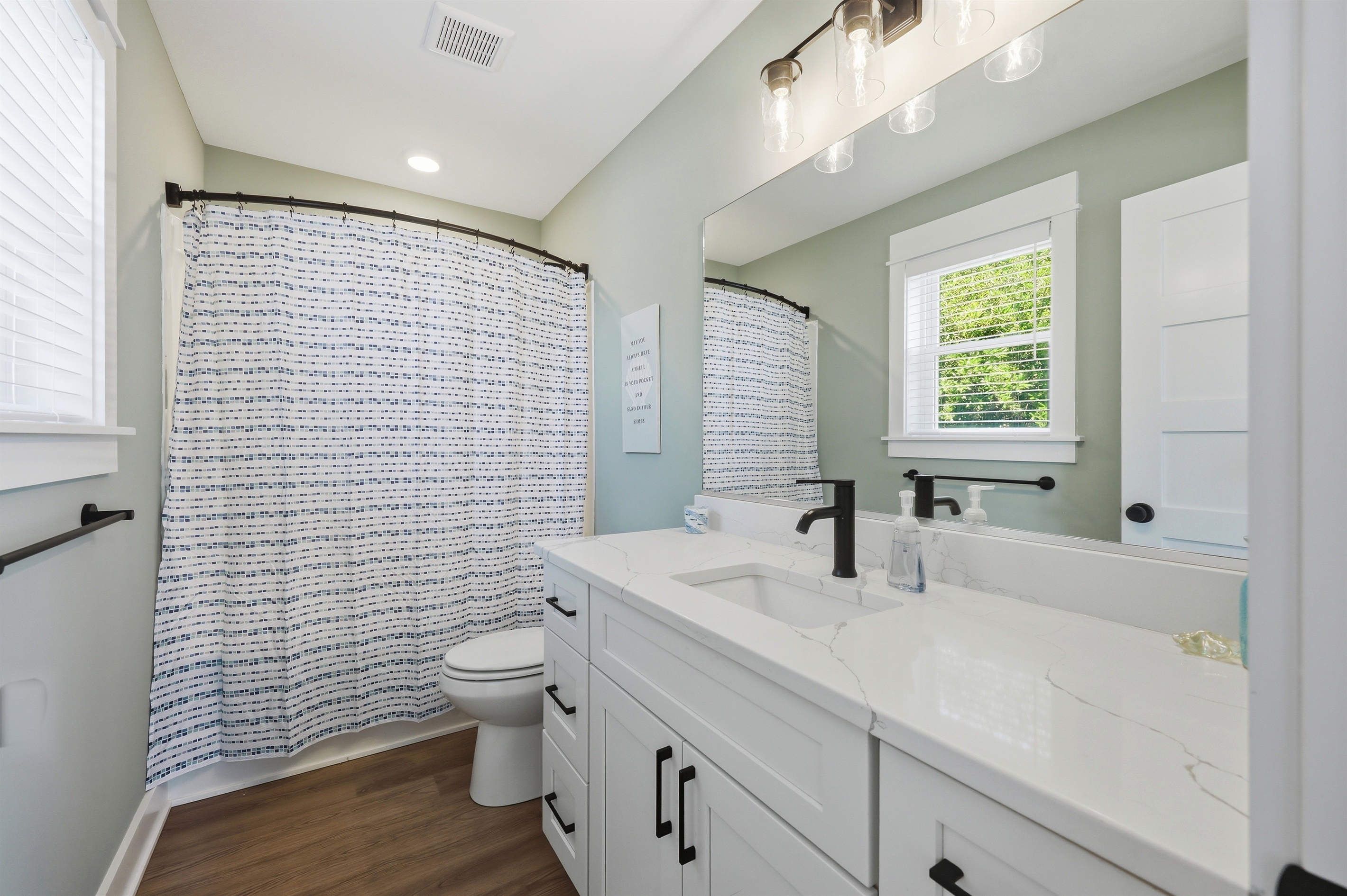 Full ensuite bathroom with spacious vanity and tub/shower combo