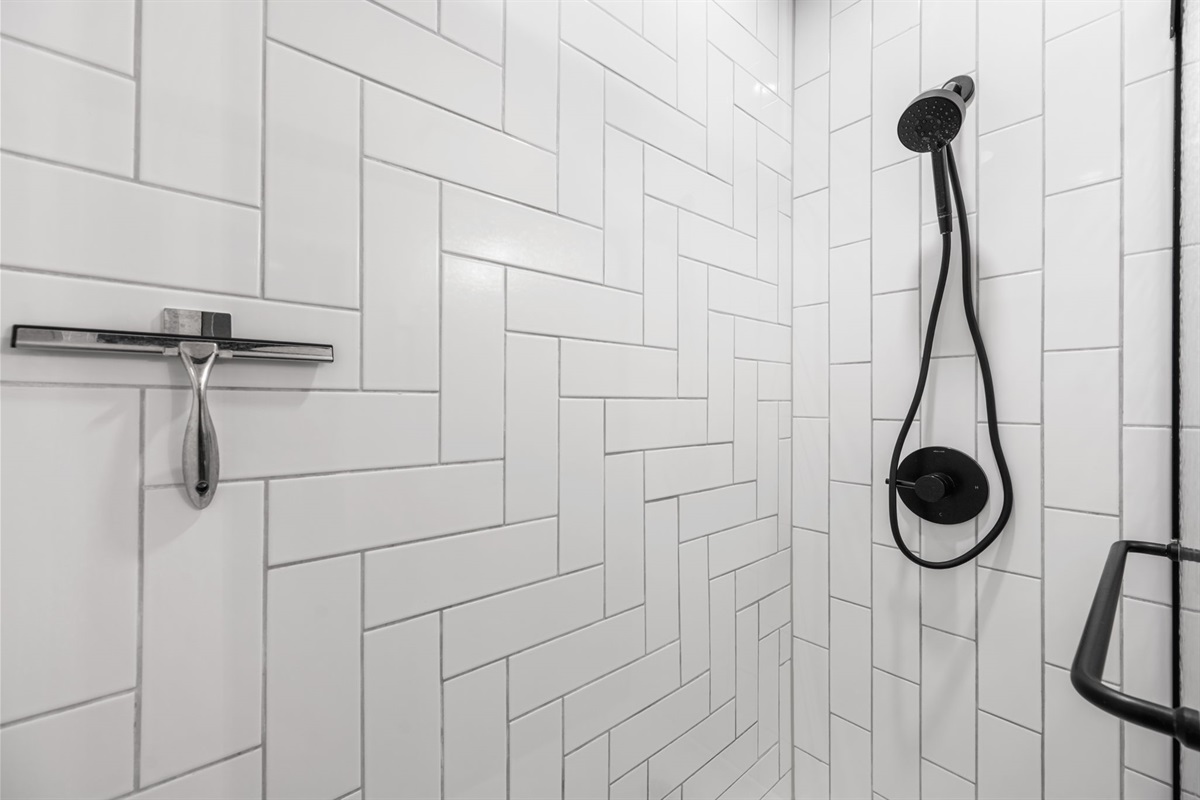 Clean, tiled walk-in shower with sleek finishes for a refreshing start