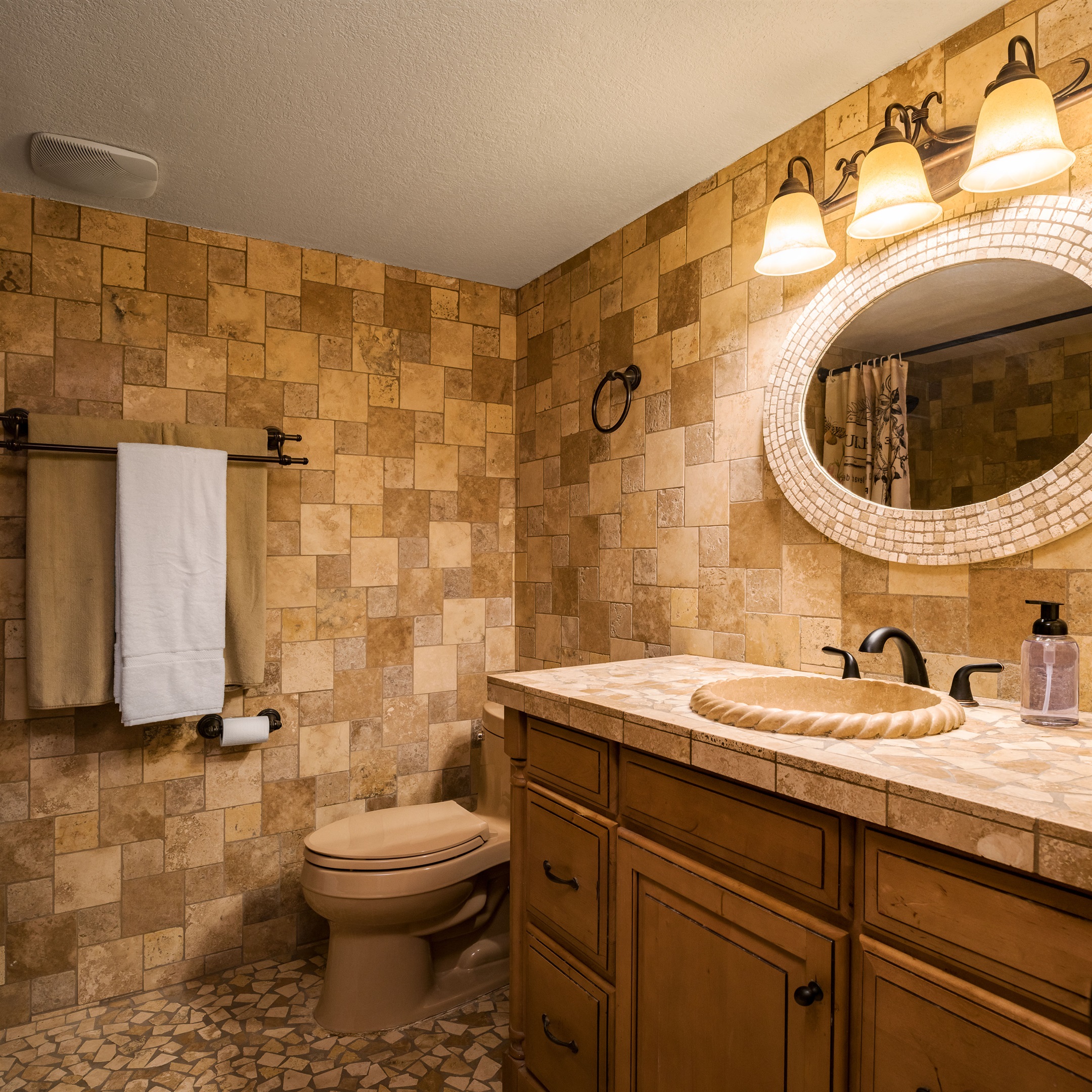 Soft lighting and earthy tilework create a warm, welcoming vibe for your morning routine or evening wind-down.