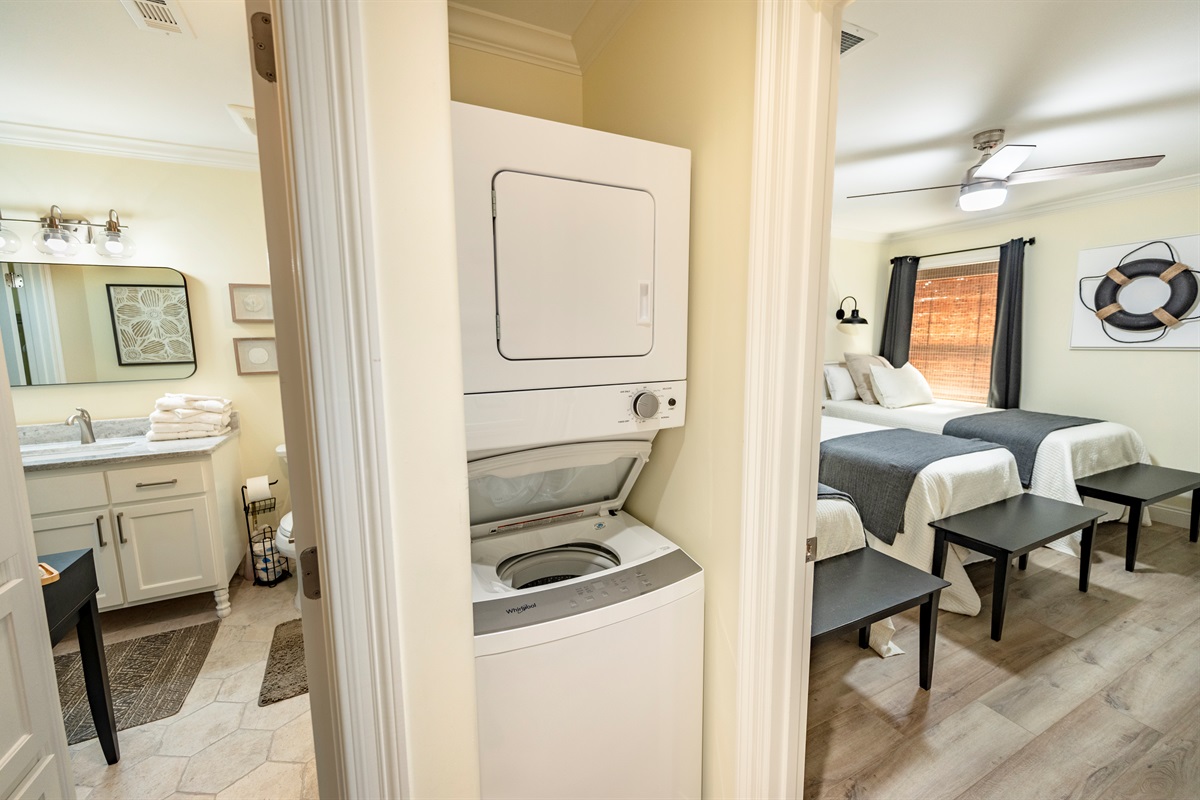 Convenient laundry nook with cozy bedroom and modern bathroom nearby.
