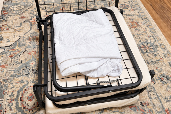 Pop up twin cot in living room ottoman