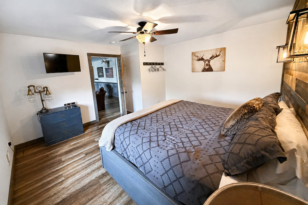 Another view of this spacious private king bed bedroom, offering comfortable sleeping accommodations, natural light, and plenty of room to settle in during your Birchwood group getaway.
