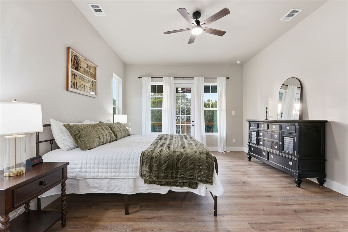 Primary suite offering generous space, natural light, and direct access to the covered deck.