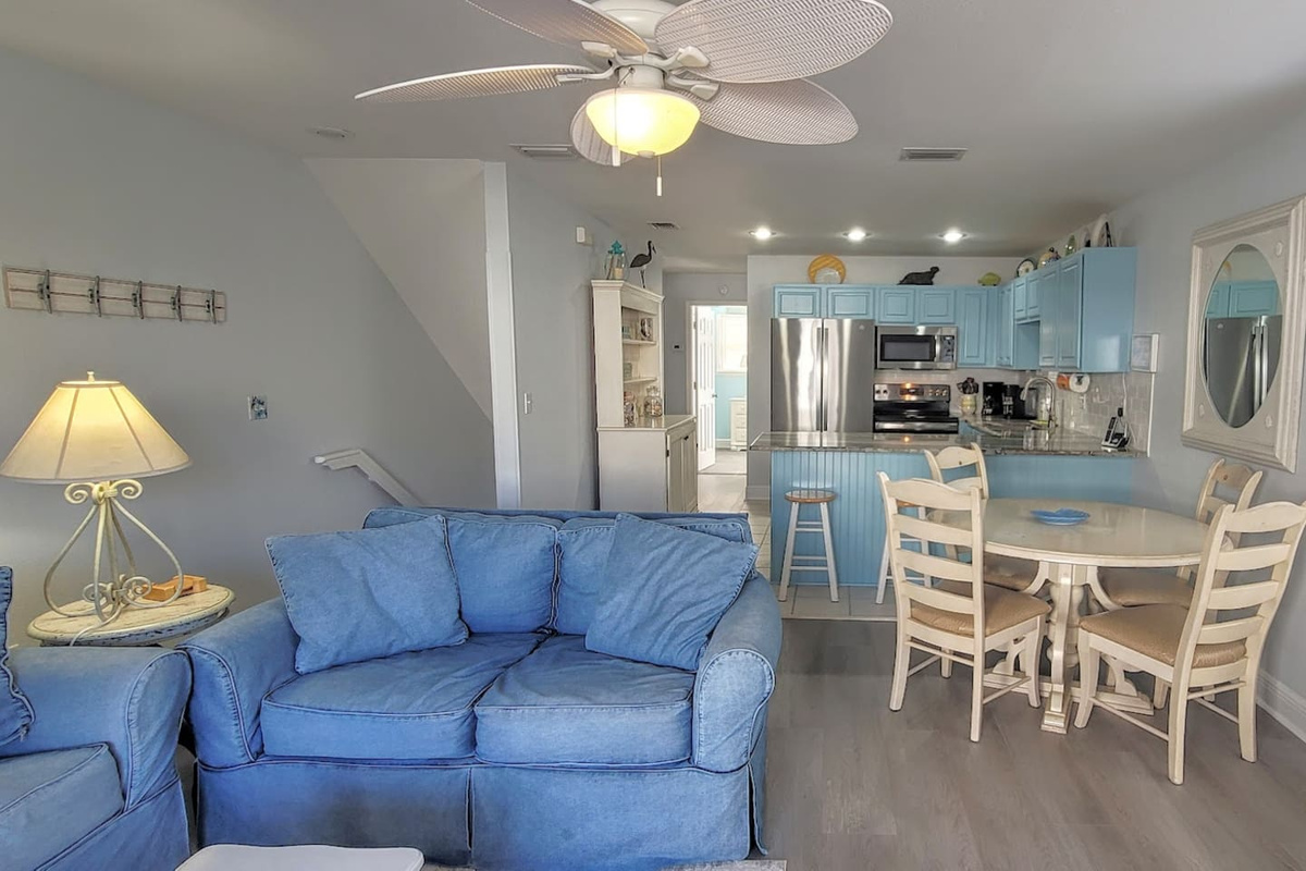 The open LVP living and kitchen area keeps the group together &mdash; easy to clean, easy to live in, easy to love.