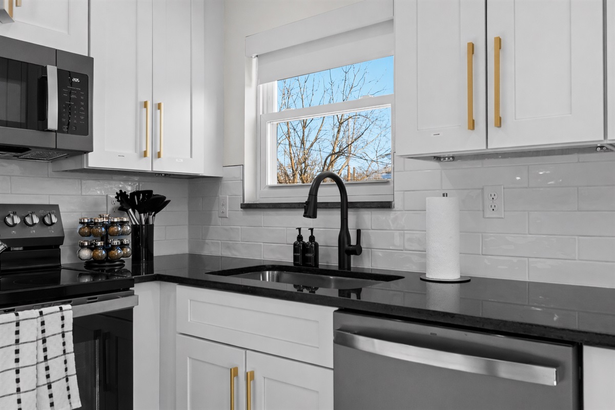 Clean, modern kitchen details with sleek countertops, stylish fixtures, and a bright window—making everyday cooking feel easy and enjoyable.