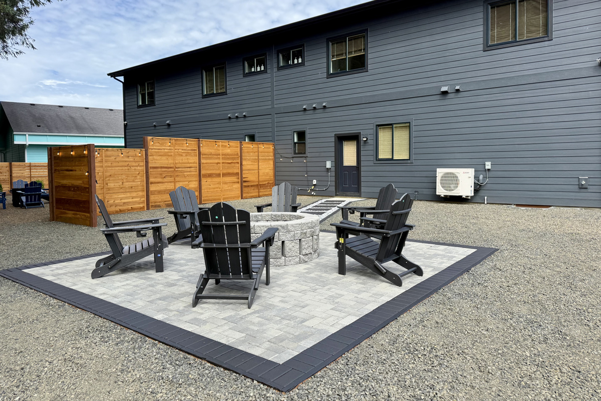 Circle up around the fire pit just steps from the back door — close enough to duck inside for another round and still keep the conversation going.