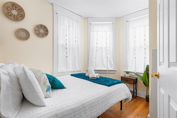 Rest easy on a comfy queen bed, bathed in natural light