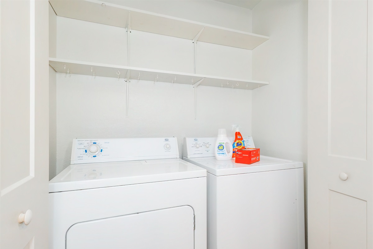 Full-size laundry setup with supplies ready to use