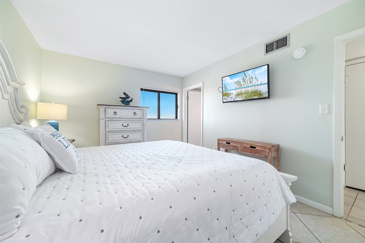 A tranquil bedroom retreat, bathed in natural light and designed with a soothing coastal palette.