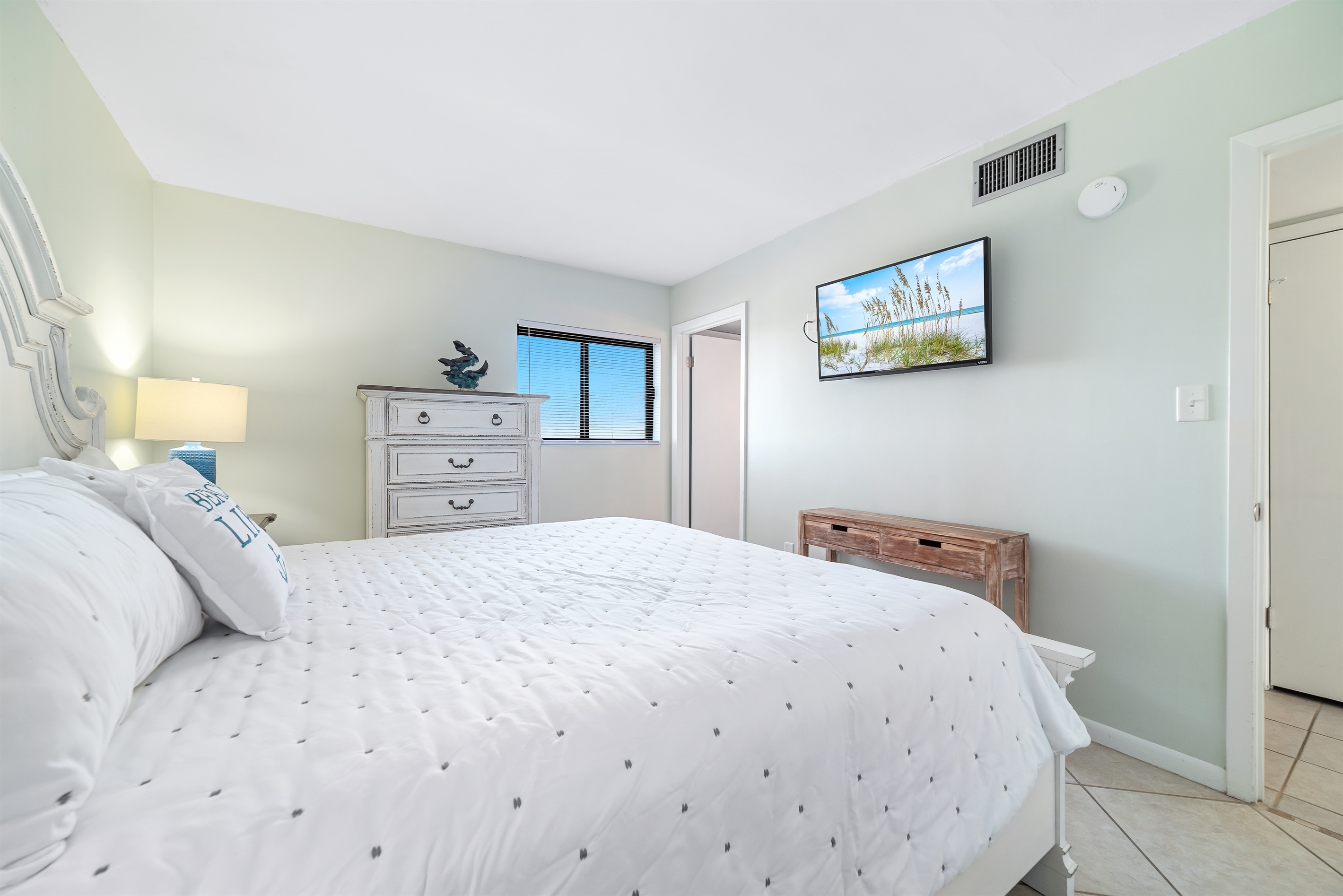 A tranquil bedroom retreat, bathed in natural light and designed with a soothing coastal palette.