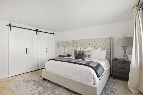Primary bedroom featuring a king bed and direct access to the ensuite bathroom