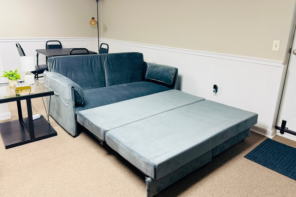 Sleeper sofa opens to provide additional sleeping space in the game room.