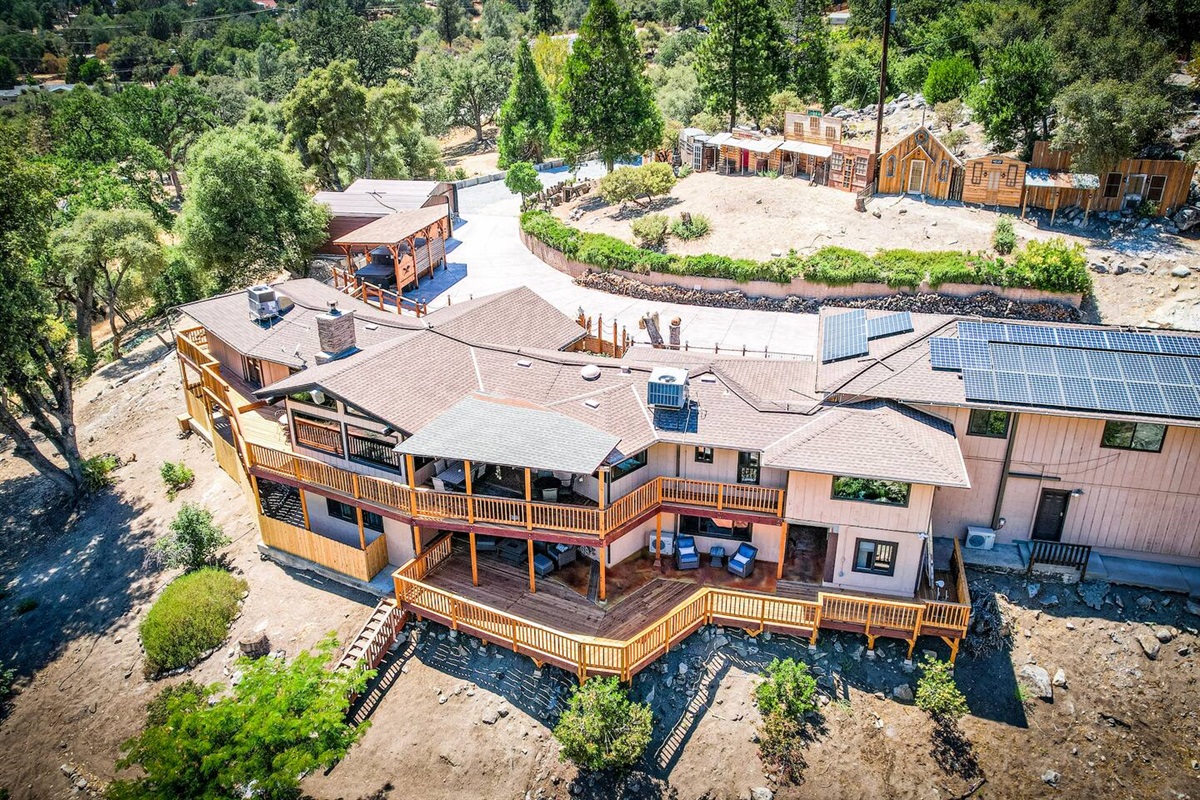 Birdseye view of the house, covered gazebo with 14 feet long jetted swimming spa, hot tub and facade of Old West Town
