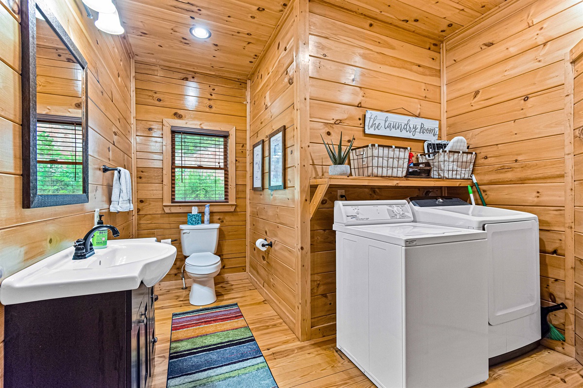 Convenient Cleanliness: This bathroom offers both a refreshing retreat and convenient laundry facilities.