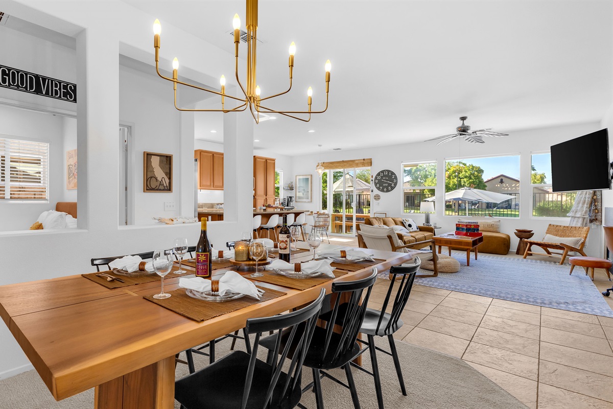 Bright open-concept dining area overlooking the living room and golf-course views