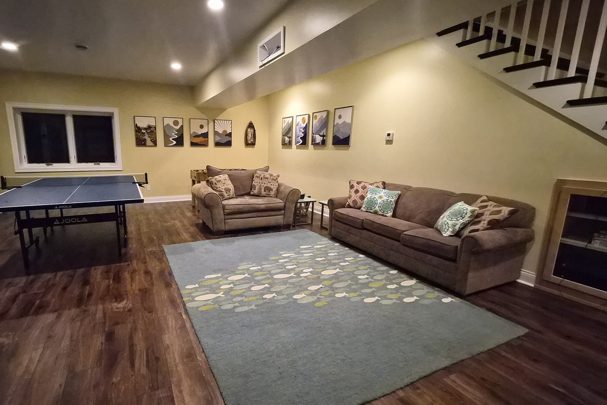 Basement with pull out sofa, ping pong table and foosball. 
