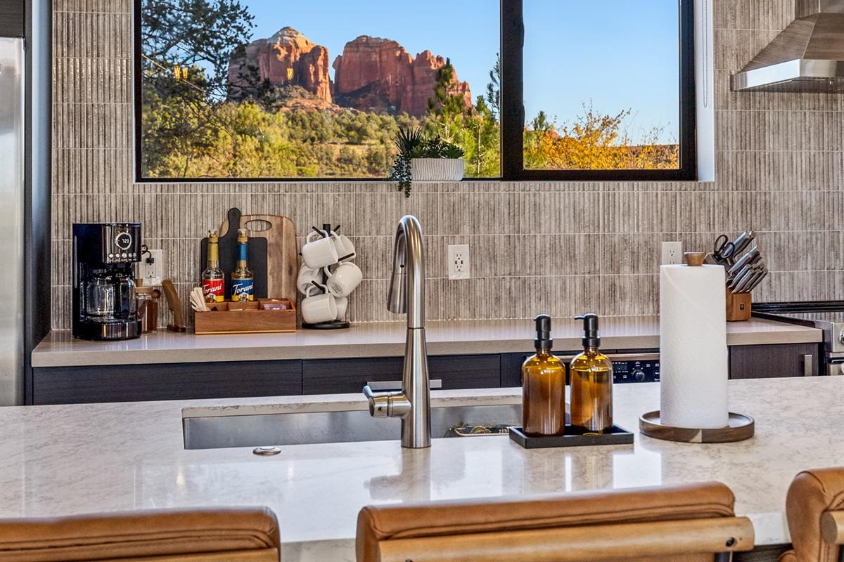 Red rock views frame the kitchen sink, bringing Sedona’s landscape into the heart of the home.