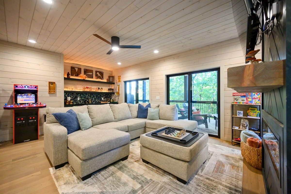 Great comfy couch in the game room with a ton of games and a mini bar with a sink and beverage fridge!