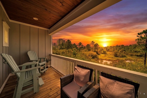 Relax on the tall Adirondack gliders with your favorite night-cap while the sun sets over the serene unobstructed wetland views.  The property joins the Gulf State Park area, so there are no houses directly behind this one.