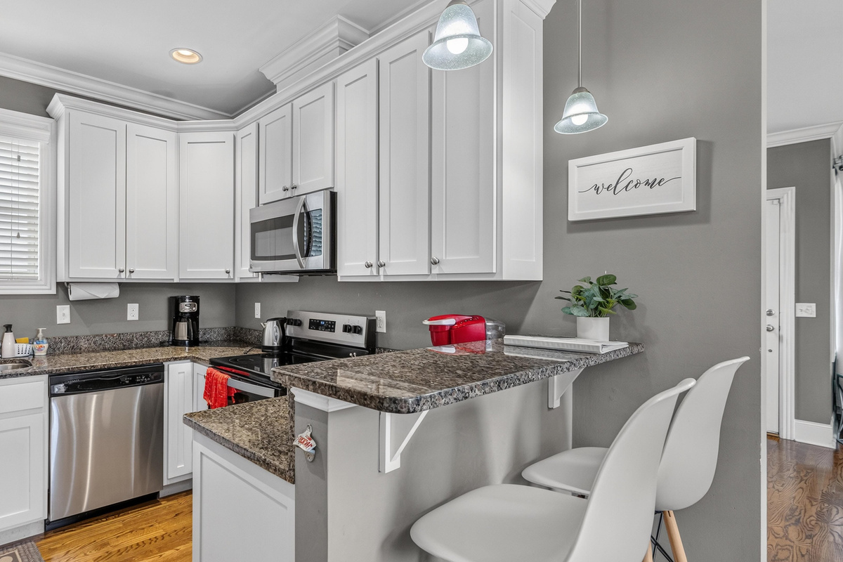 The kitchen has stainless appliances and granite counters