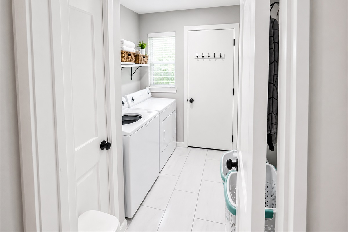 Dedicated laundry room with full-size washer and dryer — perfect for extended stays and family travel