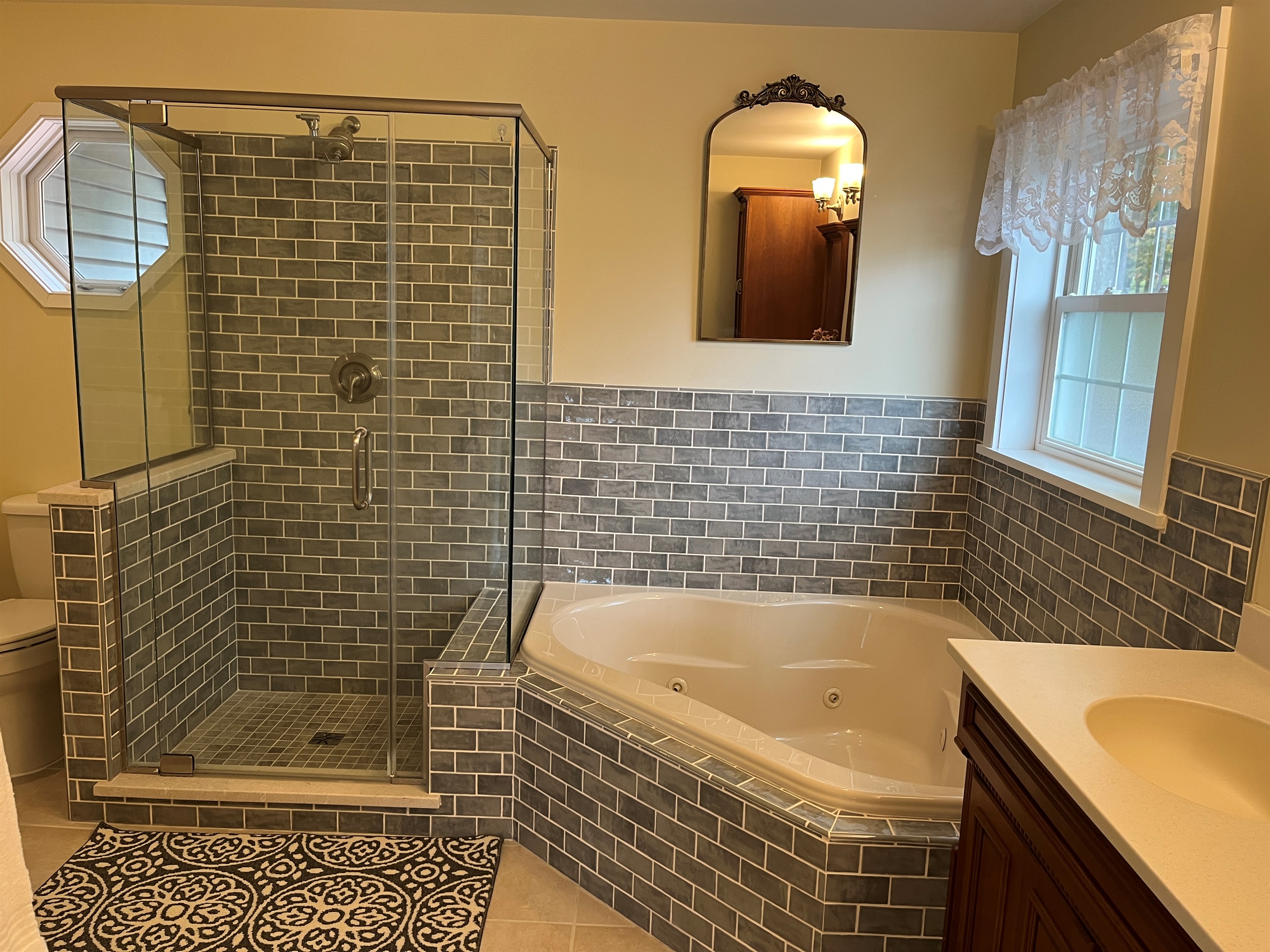 Primary bath with jetted tub and frameless glass shower