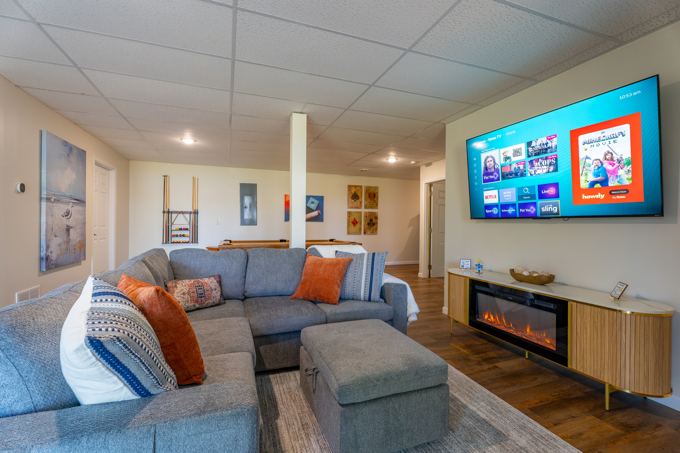 The basement lounge is where the group splits off - half upstairs watching the sunset, half down here watching the game. Both are winning!