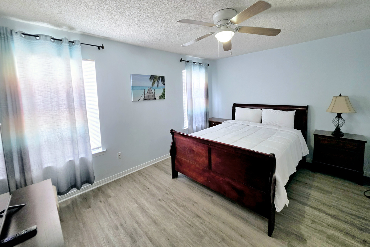 Nest side – Primary bedroom with ceiling fan and nightstands