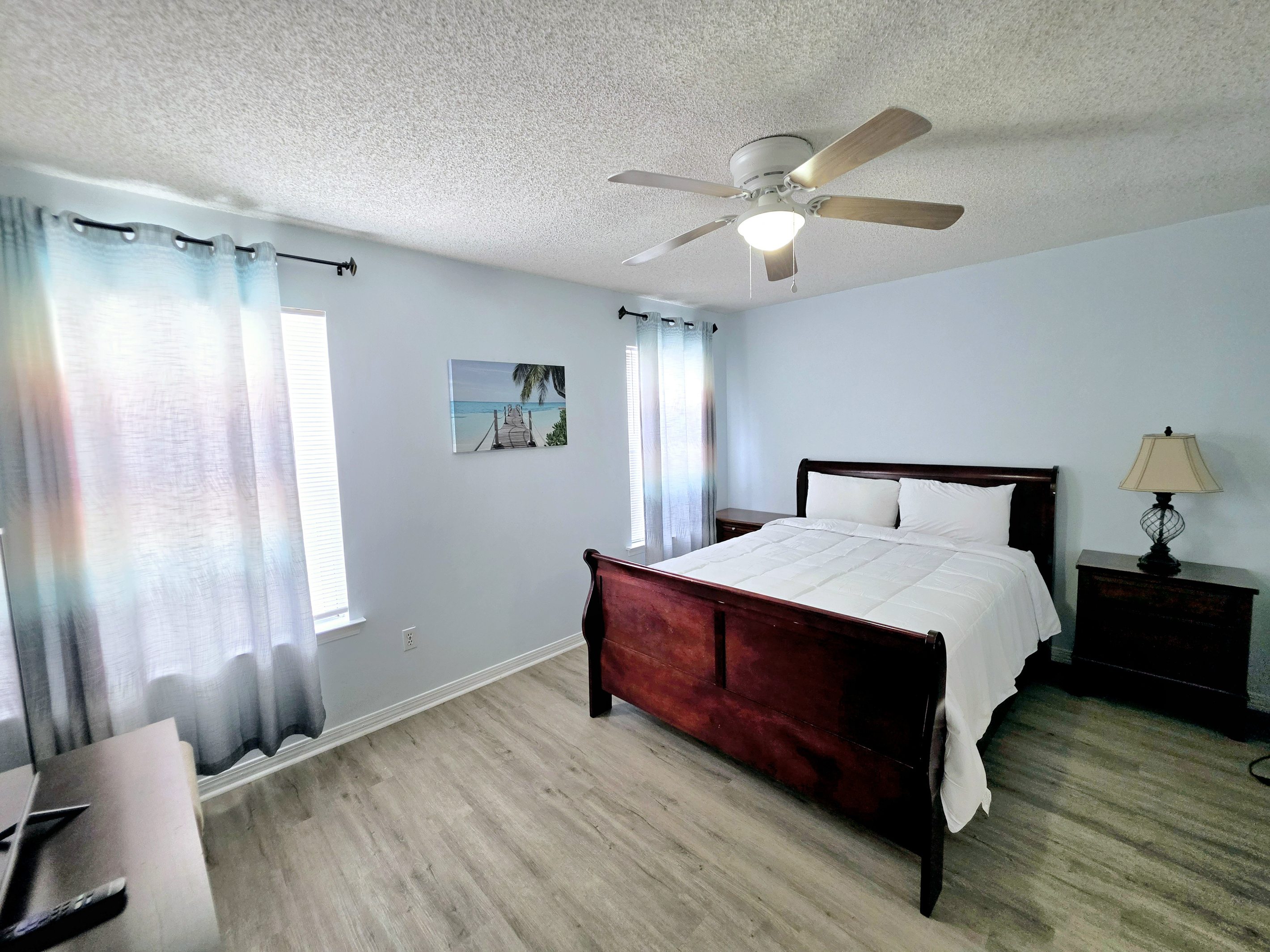 Nest side – Primary bedroom with ceiling fan and nightstands